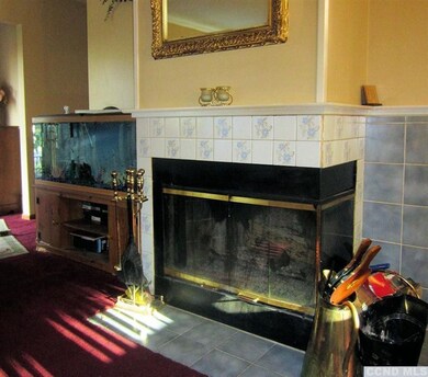 Beautiful tiled wood-burning fireplace.