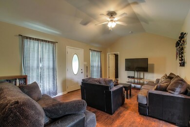 Open living room with vaulted ceilings and laminate flooring!
