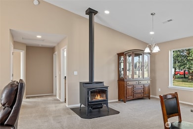 Great room with vaulted ceilings & free standing wood stove.
