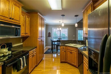 Kitchen with Oak cabinetry and wood floors. Upgrad