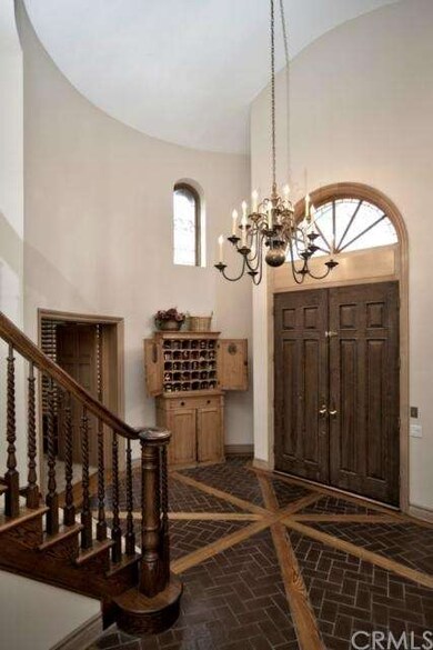 Formal entry with a chandelier accented with brick
