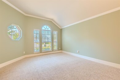 Unfurnished room with vaulted ceiling, crown molding, and carpet flooring