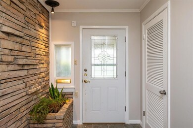 Entry with a built-in planter, coat closet and til