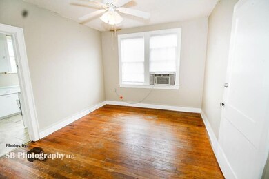 Tiled spare room featuring ceiling fan