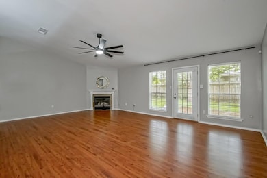 Living room with wood burning fireplace, high ceil