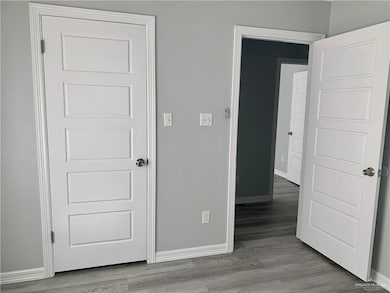 Unfurnished bedroom featuring baseboards and light wood-style flooring