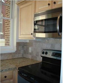 The kitchen is equipped with stainless appliances,