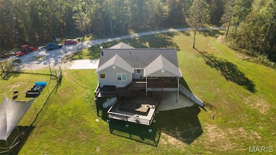 Aerial view of property and surrounding area featuring a heavily wooded area