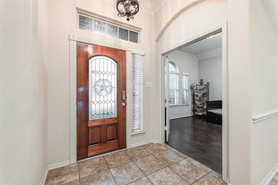 Welcome home! Be invited into this fantastic home that features a large, bright foyer with formal living that has been converted to a study, gorgeous tile floors, beautiful chandelier, and elegant archways.