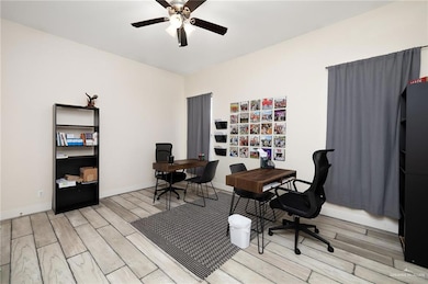 Office space with ceiling fan and light hardwood / wood-style floors