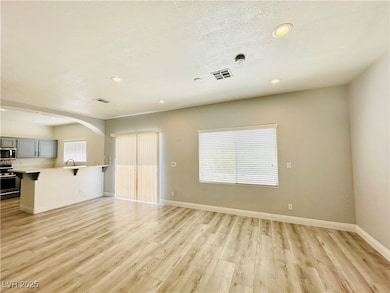 Unfurnished living room featuring light wood-style