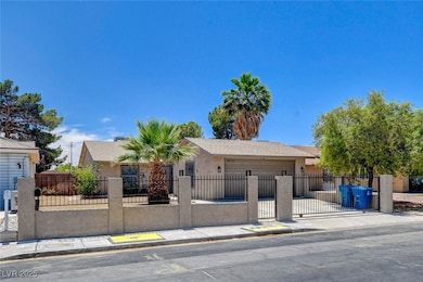 View of front facade featuring a garage, a fenced