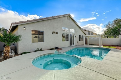 View of pool with a pool with connected hot tub, a