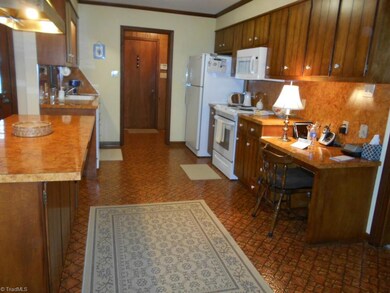 Kitchen with built in desk includes dishwasher, disposal, slide-in oven/range and a built-in microwave.