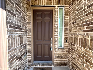 Entrance to property with brick siding