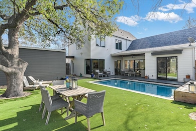 Rear view of house featuring an outdoor pool, a l