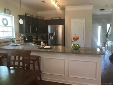 Kitchen with granite counters, tile backsplash, st