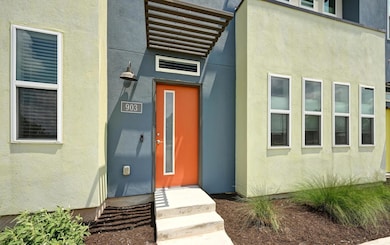 Doorway to property featuring elevator and stucco