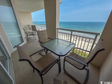 Balcony with a water view and a view of the beach