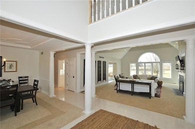 The view from the entry foyer illustrates the wide open feeling into the great room and kitchen to the left, along with a formal dining room near left. Perfect for entertaining guests and family.