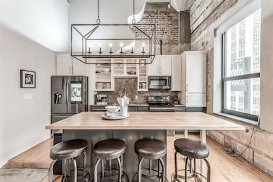 Updated kitchen featuring concrete countertops, mo