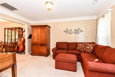 Formal Living Room with 2 windows opens to Formal Dining Room.