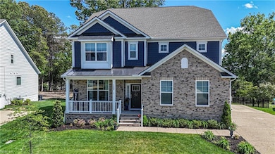 132 Royal Blackheath has a welcoming front porch with stone veneer accent.