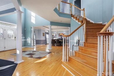 A view of the Foyer, Dining room, and Staircase