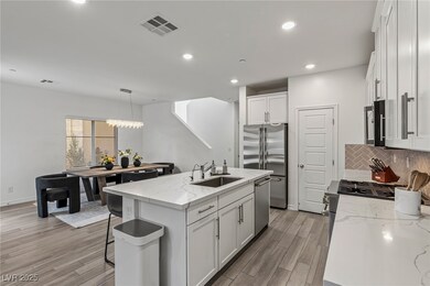 Kitchen with backsplash, a sink, appliances with s