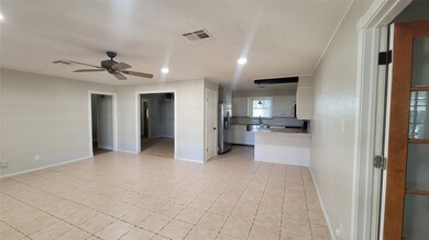 Another view of the family room with ceiling fan a