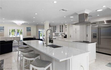 Kitchen featuring black electric cooktop, island r