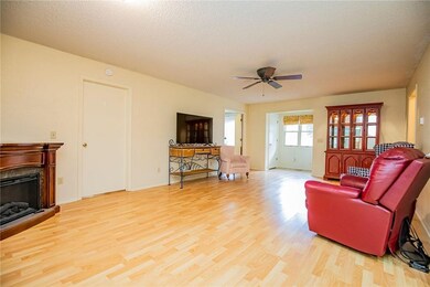 Living room looking toward front entrance to the back and the back left door is a bedroom.
