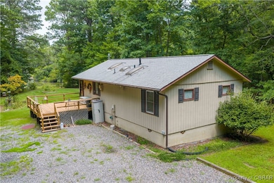 Rear view of dwelling featuring a deck with unobstructed view of water