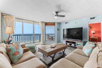 Living room with ceiling fan, expansive windows, a