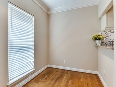 Spare room with ornamental molding and light wood-style flooring