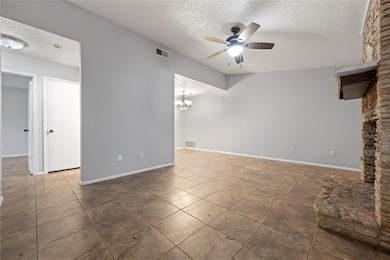 Unfurnished living room featuring a textured ceil