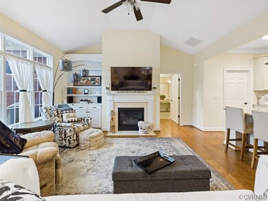 ANOTHER VIEW OF THE FAMILY ROOM WITH CUSTOM BUILT-INS AND GAS FIREPLACE.