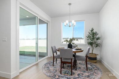 Dining area with a chandelier and light wood-style floors