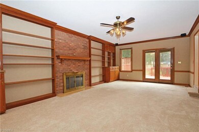 Huge family room with gas log fireplace and built-ins. Doors lead to deck.