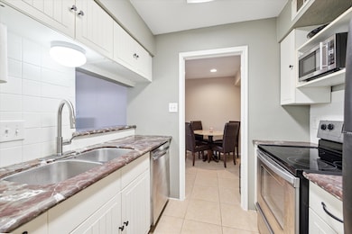 Cute kitchen with beautiful marble countertops.  A