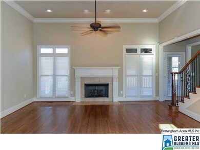 Family room with hardwood flooring, high ceilings 