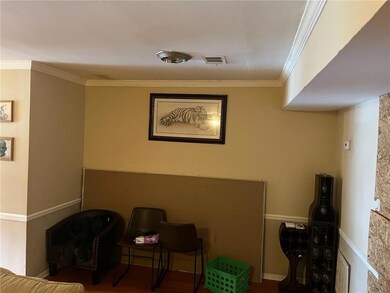 Sitting room with ornamental molding and baseboards