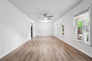 Unfurnished room featuring baseboards, wood finished floors, and ceiling fan