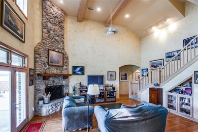 Living room with beamed  ceiling, stone fireplace,
