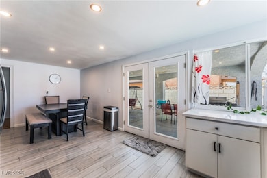 Dining room with french doors, light wood-style fl