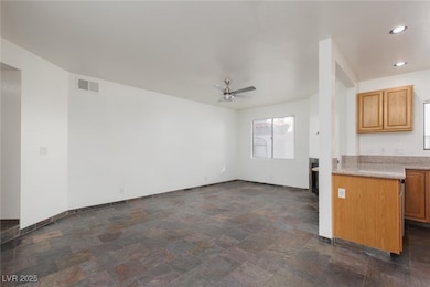 Unfurnished living room with dark stone finish floors, recessed lighting, and ceiling fan