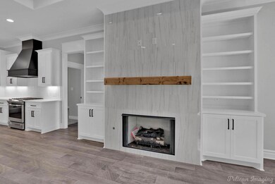 Unfurnished living room featuring crown molding, a