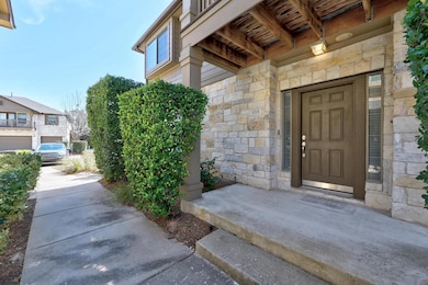 View of exterior entry featuring stone siding