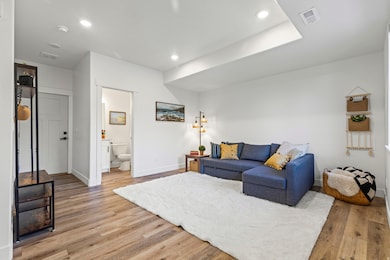 Living room featuring light wood-type flooring and recessed lighting