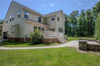 Rear view of property featuring a deck and a yard